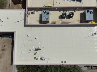 Applying a silicone roof coating to a TPO roof in Scottsdale, AZ