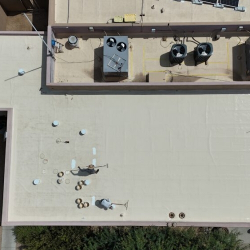 Applying a silicone roof coating to a TPO roof in Scottsdale, AZ