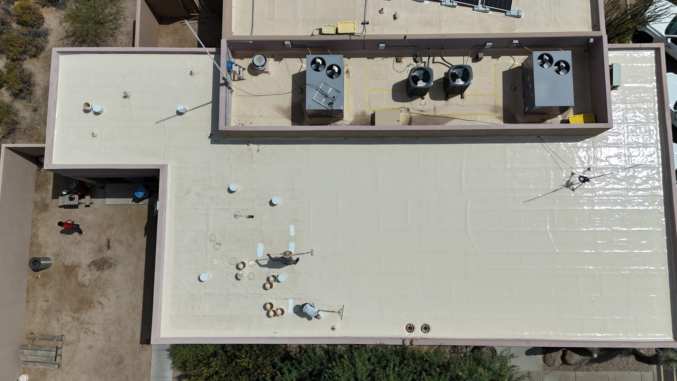 Applying a silicone roof coating to a TPO roof in Scottsdale, AZ