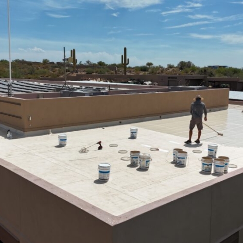Applying a silicone roof coating to a TPO roof in Scottsdale, AZ