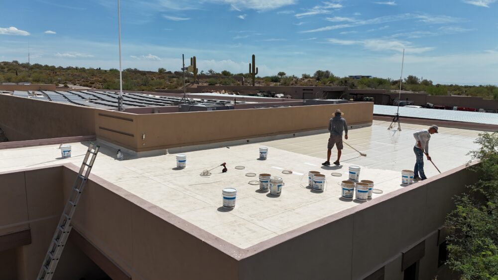 Desert State Roofing team applying roof coating in Cave Creek AZ